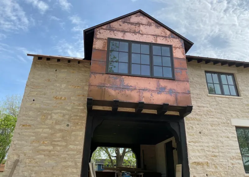 Copper metal panel facade on a stone building for Metal Roof Coating in Rincon